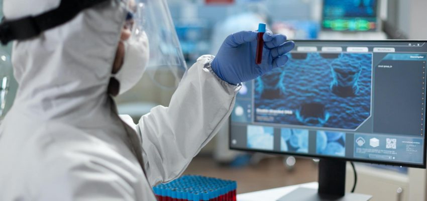 Chemist researcher holding medical test tube with genetic blood in hands